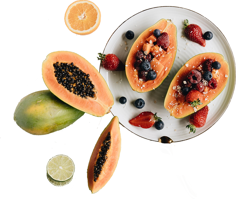A few papayas sliced in half stuffed with berries and citrus fruits.